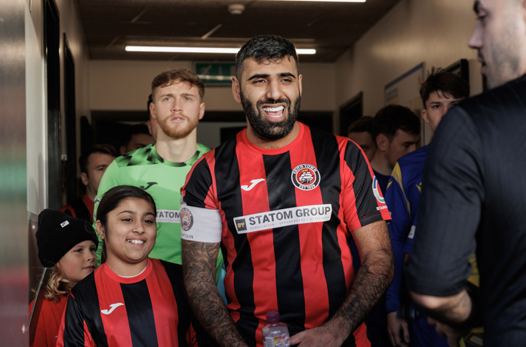 Ryan Mahal leads the team out with Mascot Aleena