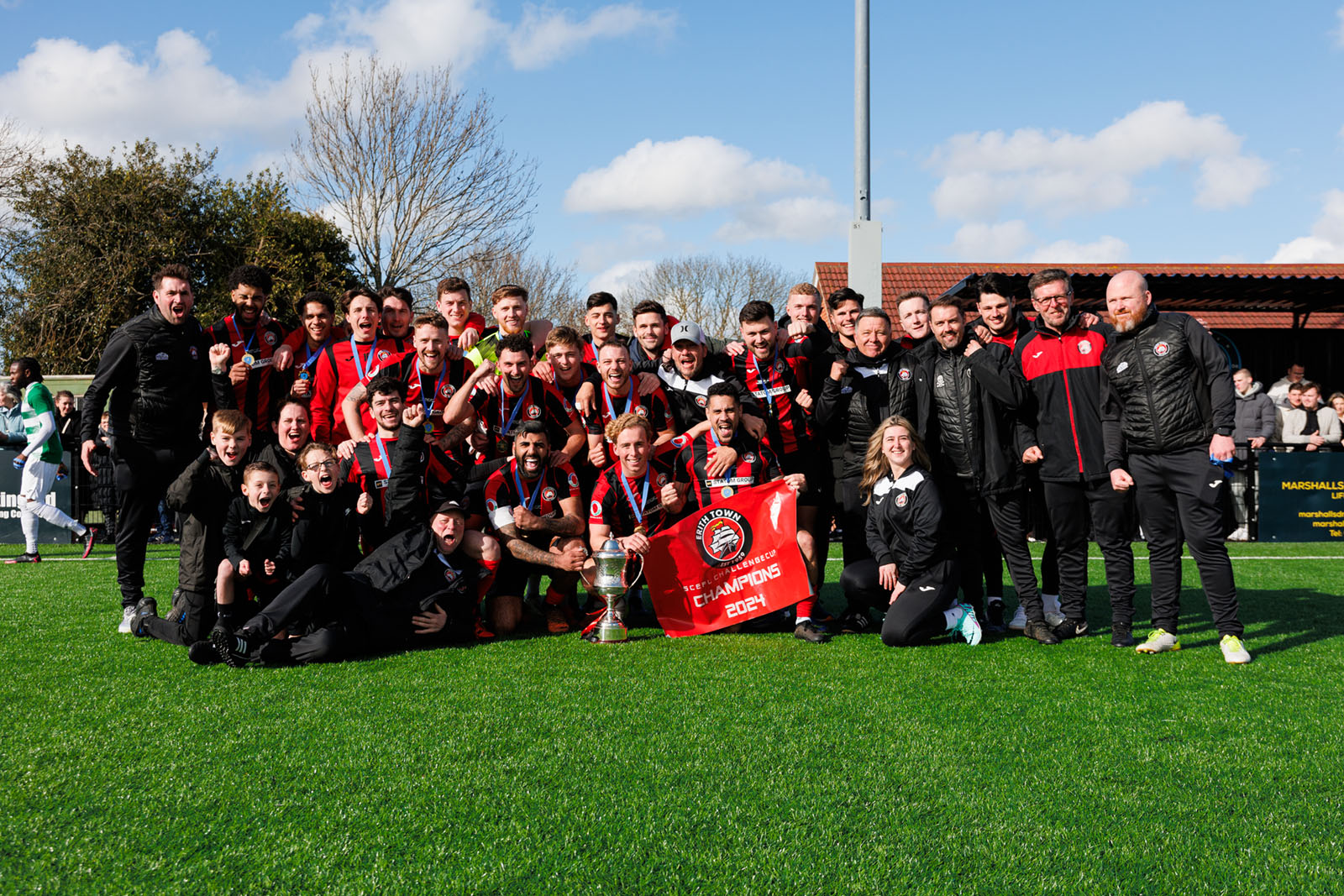 Players, management, coaches and staff celebrate the SCEFL Challenge Cup final win.
